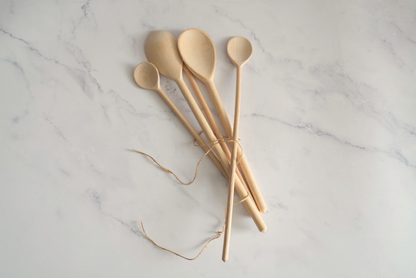 Kitchen gift set with a heart charcuterie board, kitchen towels, and beechwood spoons.