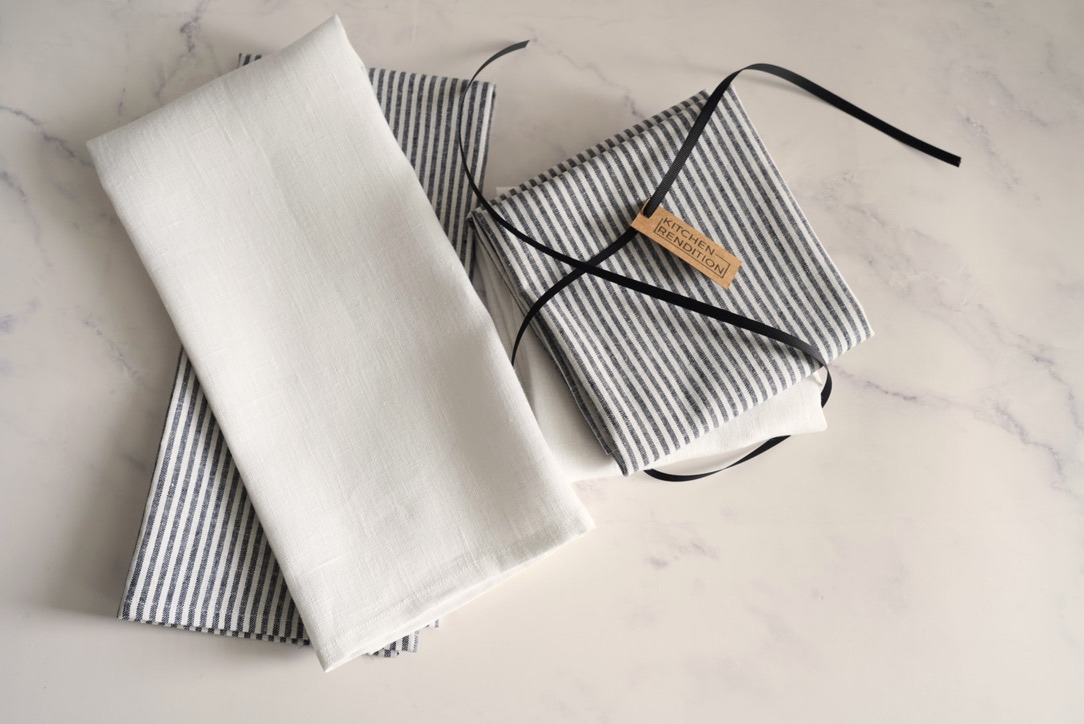 Kitchen gift set with a heart charcuterie board, kitchen towels, and beechwood spoons.